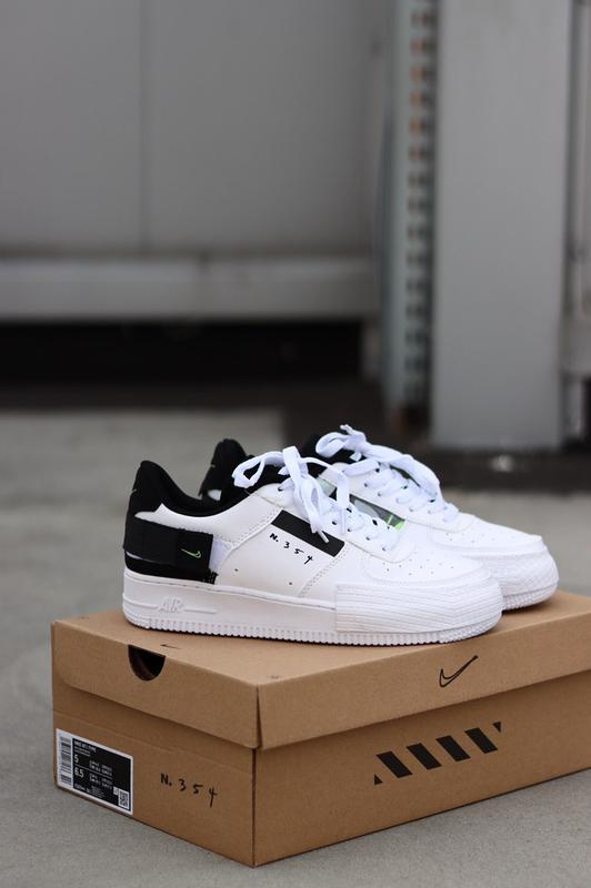 black air forces with white nike sign